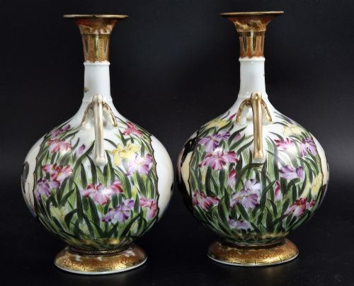 fig 1. A pair of Japanese Yokohama porcelain vases decorated with hand-painted figures, floral irises, twin gilt handles, and gilded neck details.