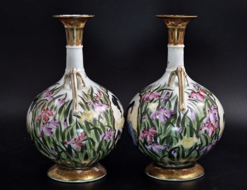 fig 3. A pair of Japanese Yokohama porcelain vases decorated with hand-painted figures, floral irises, twin gilt handles, and gilded neck details.