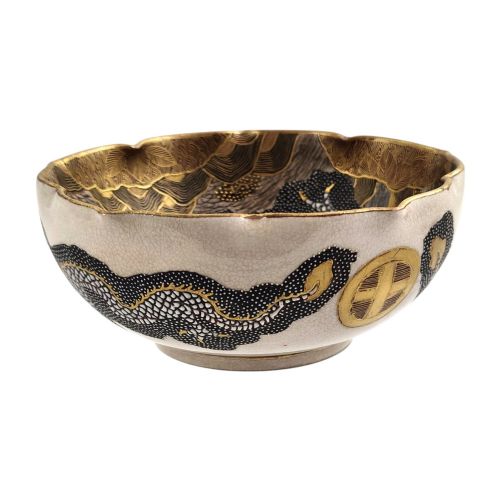 fig 1. A lobed Japanese Satsuma earthenware bowl featuring detailed hand-painted figures of Rakan and a dragon accented with gold enamelling.