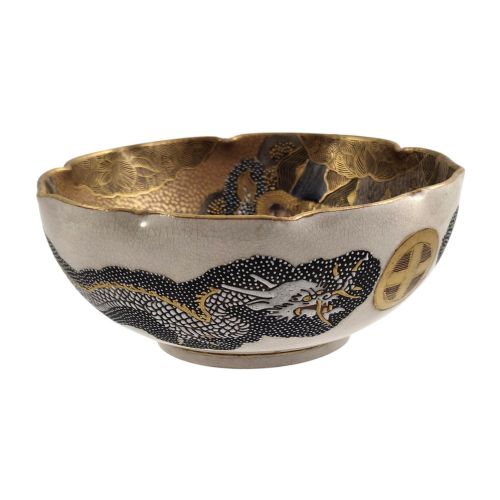 fig 3. A lobed Japanese Satsuma earthenware bowl featuring detailed hand-painted figures of Rakan and a dragon accented with gold enamelling.