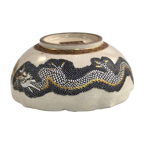 fig 5. A lobed Japanese Satsuma earthenware bowl featuring detailed hand-painted figures of Rakan and a dragon accented with gold enamelling.