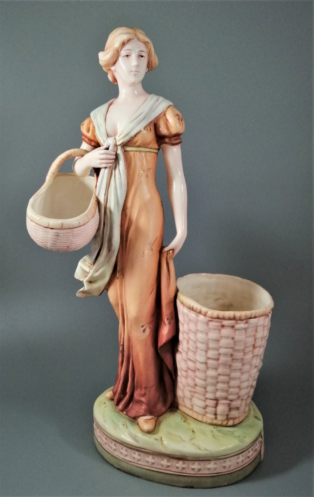 Antique Royal Dux figurine of a woman with wicker baskets