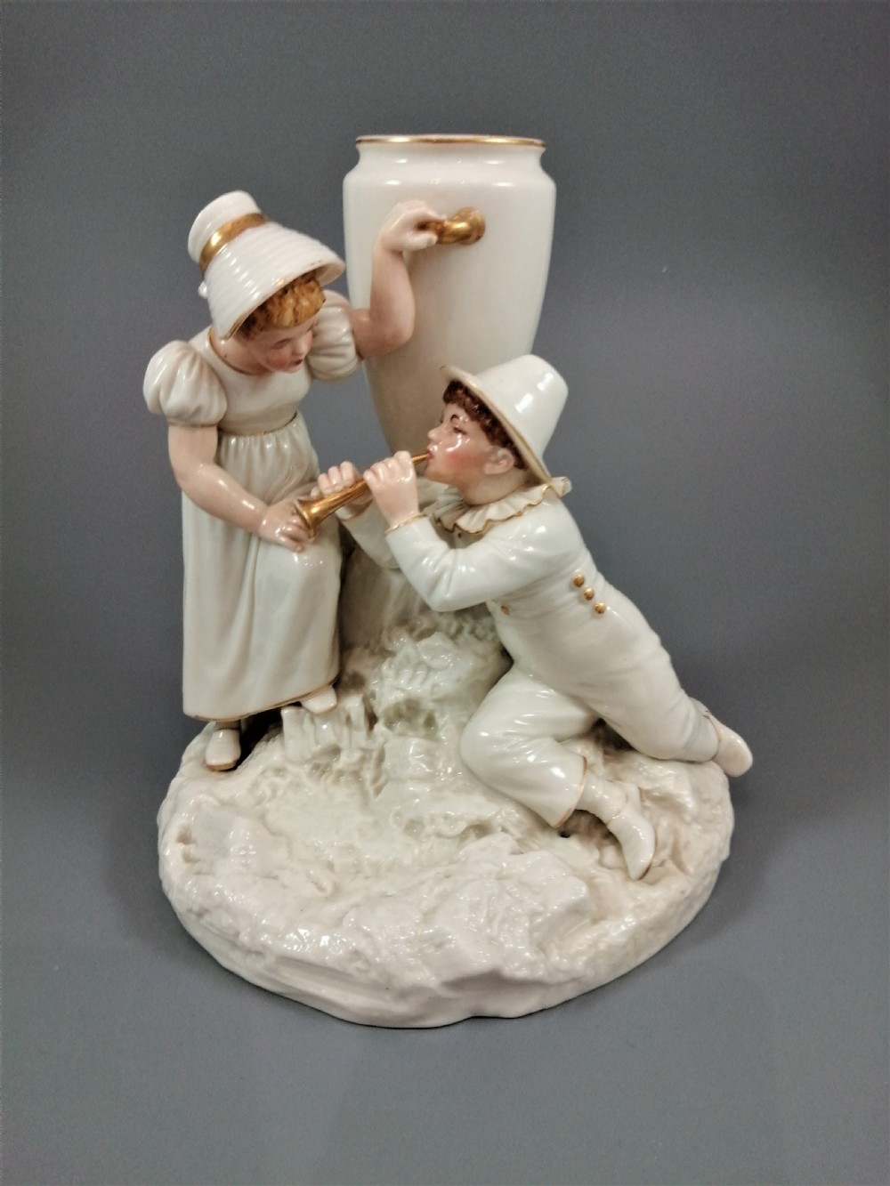 Royal Worcester group: boy with horn and girl . James Hadley, 1881.