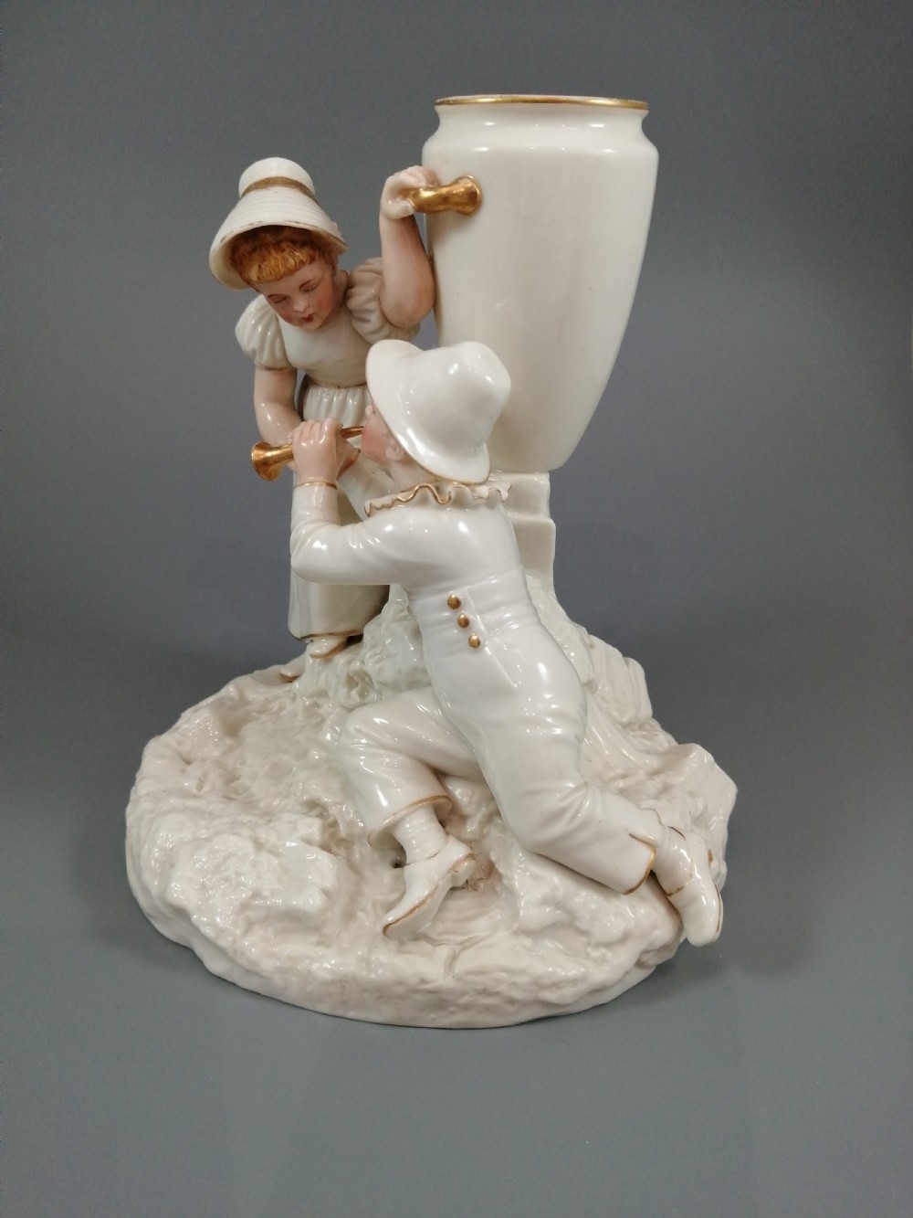 Royal Worcester group: boy with horn and girl . James Hadley, 1881. View III