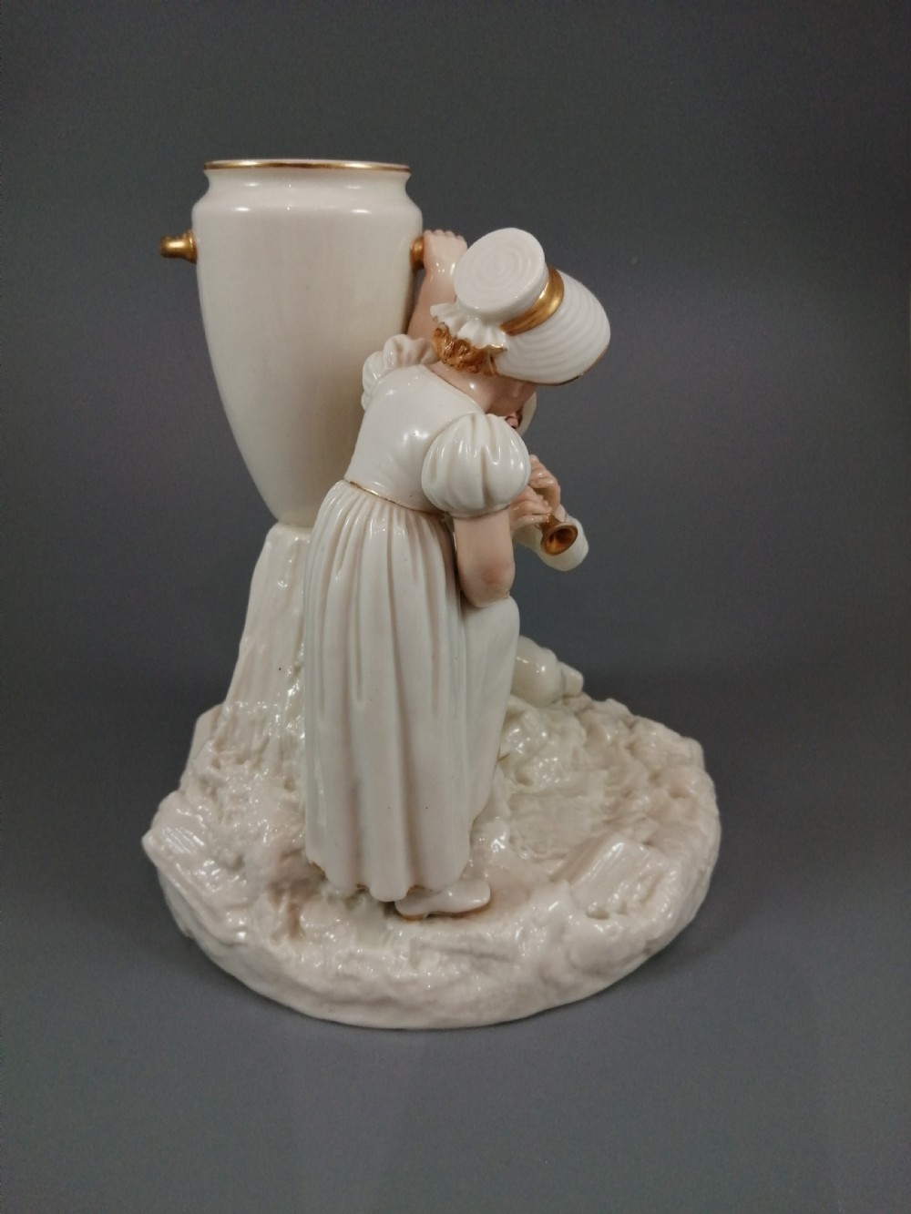 Royal Worcester group: boy with horn and girl . James Hadley, 1881. View IX