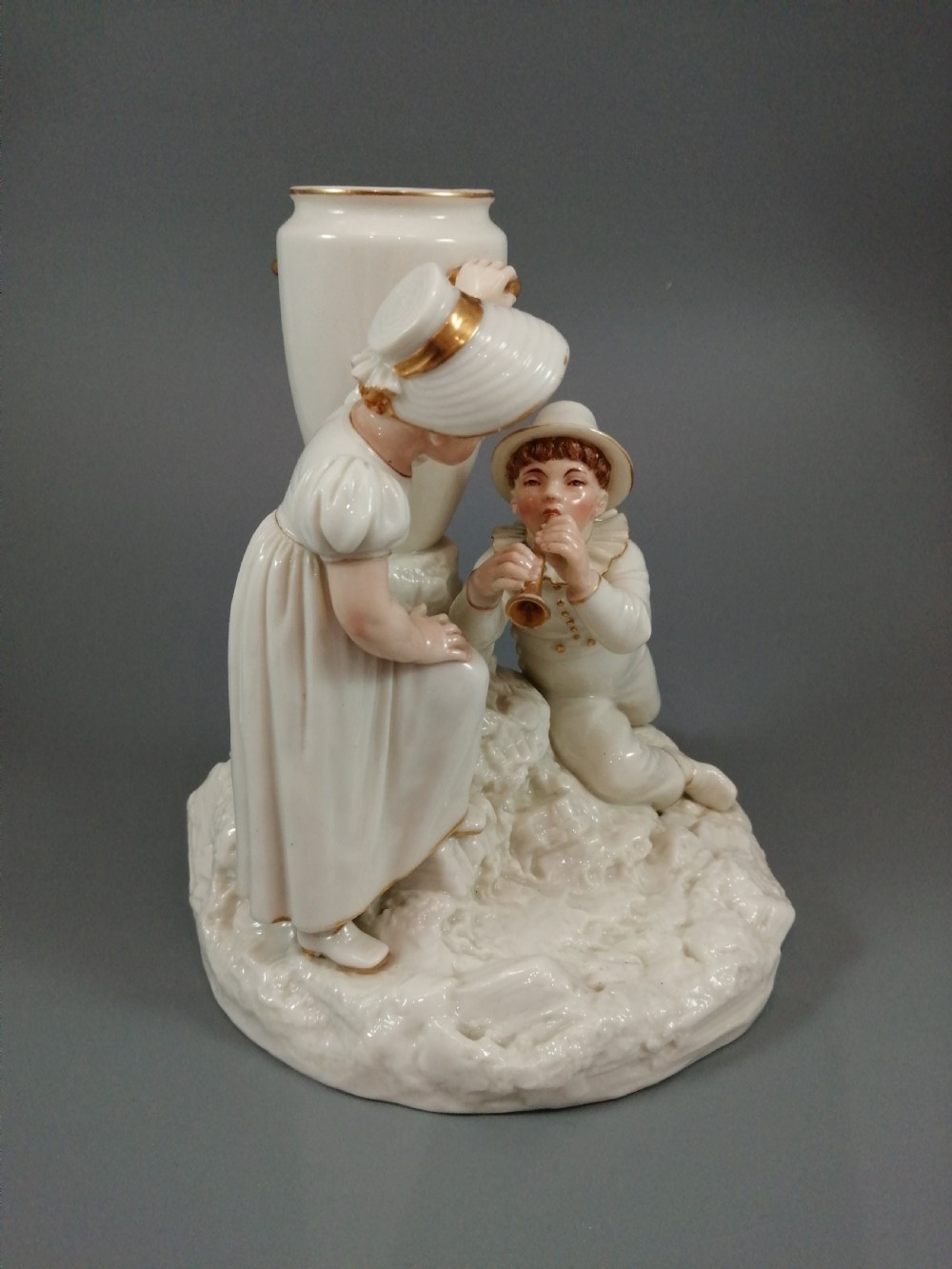 Royal Worcester group: boy with horn and girl . James Hadley, 1881. View X