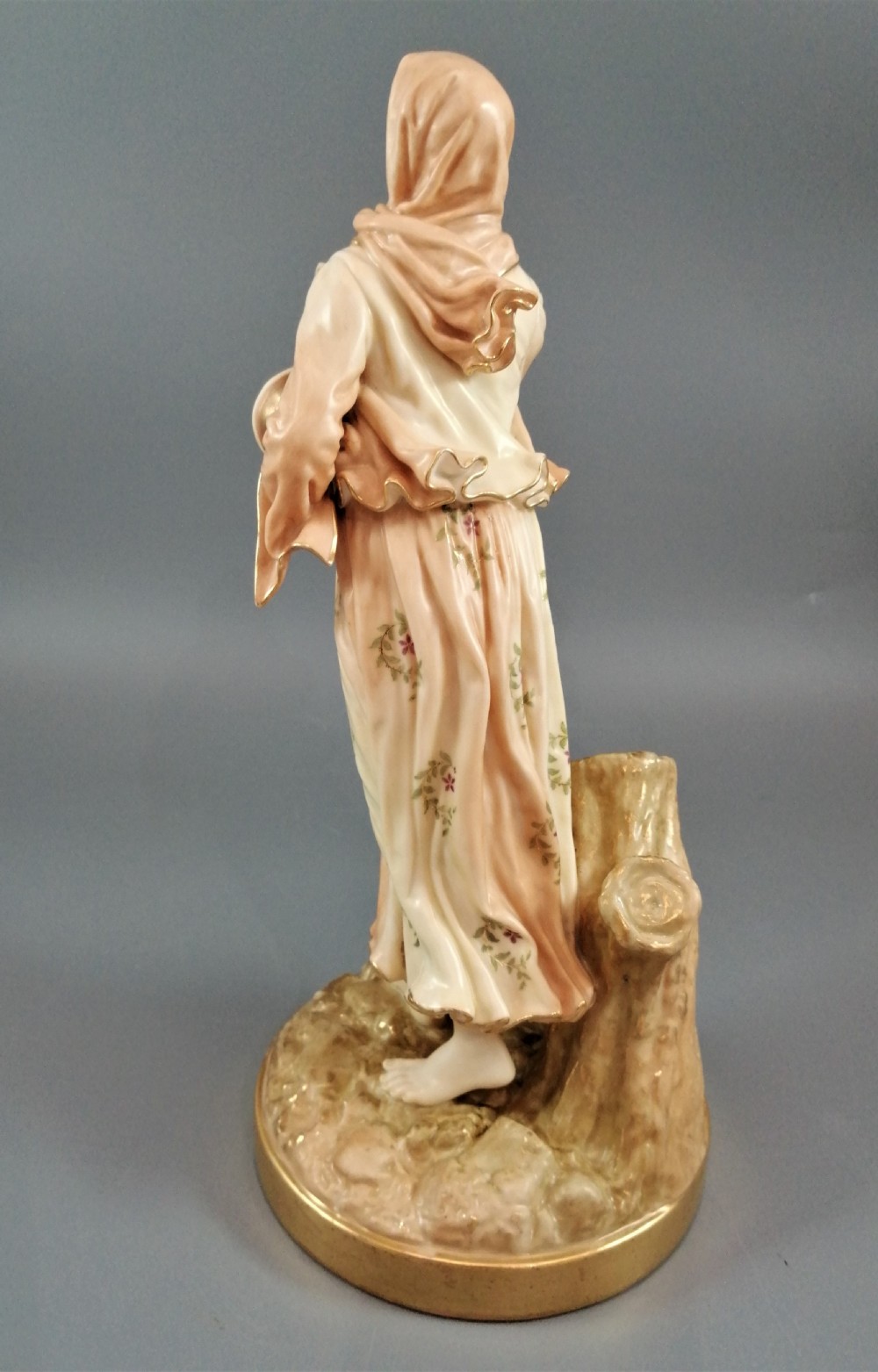 A late Victorian Royal Worcester porcelain figurine depicting a standing female musician in draped robes holding a hand drum. View III