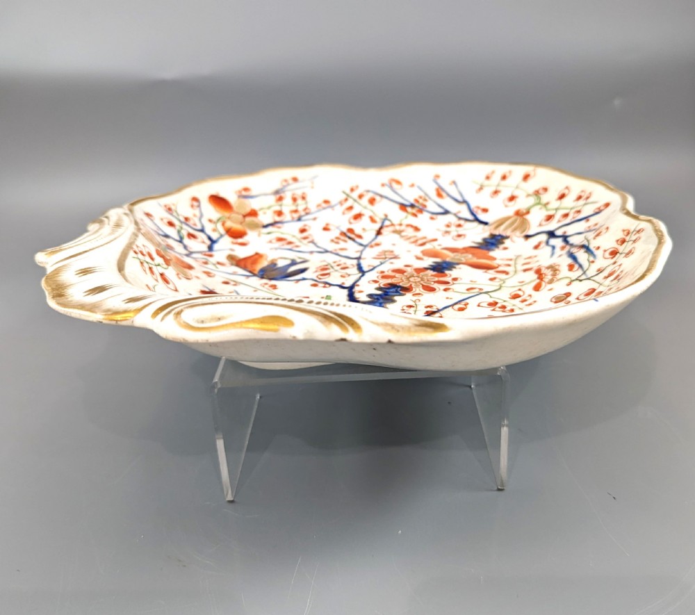An antique shell-shaped porcelain plate featuring hand-painted Kakiemon-style motifs of two quails beneath flowering branches with gilt highlights. View V