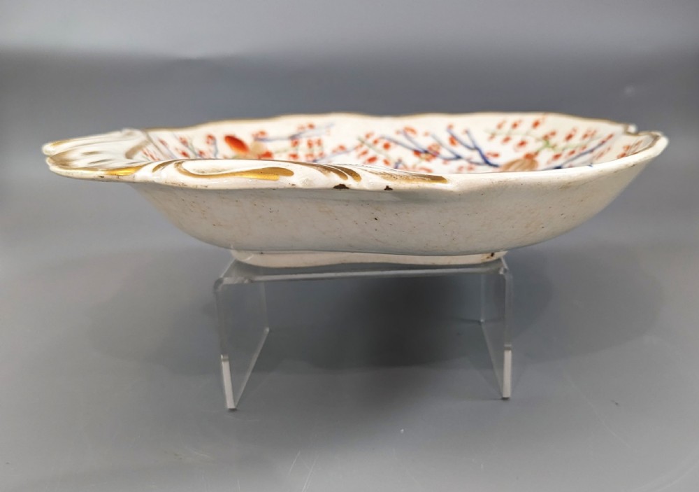 An antique shell-shaped porcelain plate featuring hand-painted Kakiemon-style motifs of two quails beneath flowering branches with gilt highlights. View VI