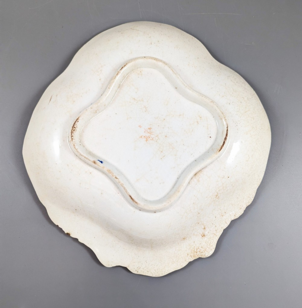 An antique shell-shaped porcelain plate featuring hand-painted Kakiemon-style motifs of two quails beneath flowering branches with gilt highlights. View VIII