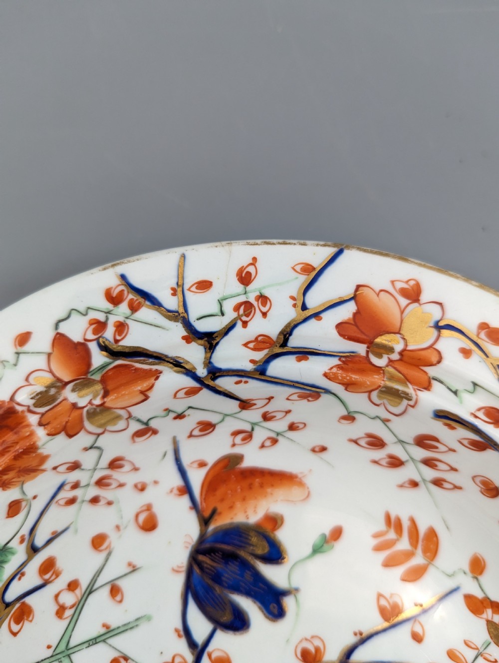 A circular antique porcelain butter dish with stand, decorated with hand-painted Japanese Kakiemon style quail and floral motifs in iron-red, blue, and gold. View XIII