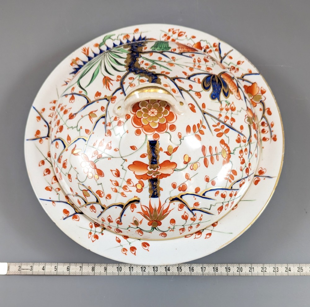 A circular antique porcelain butter dish with stand, decorated with hand-painted Japanese Kakiemon style quail and floral motifs in iron-red, blue, and gold. View XIV