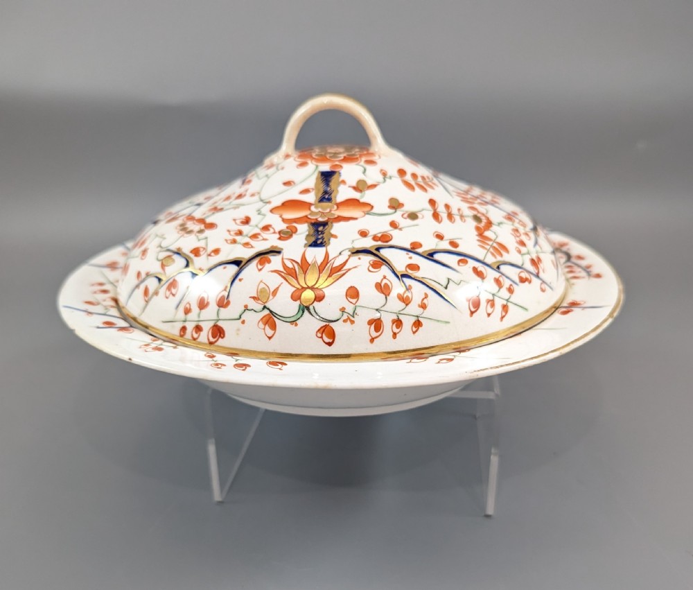 A circular antique porcelain butter dish with stand, decorated with hand-painted Japanese Kakiemon style quail and floral motifs in iron-red, blue, and gold. View XV