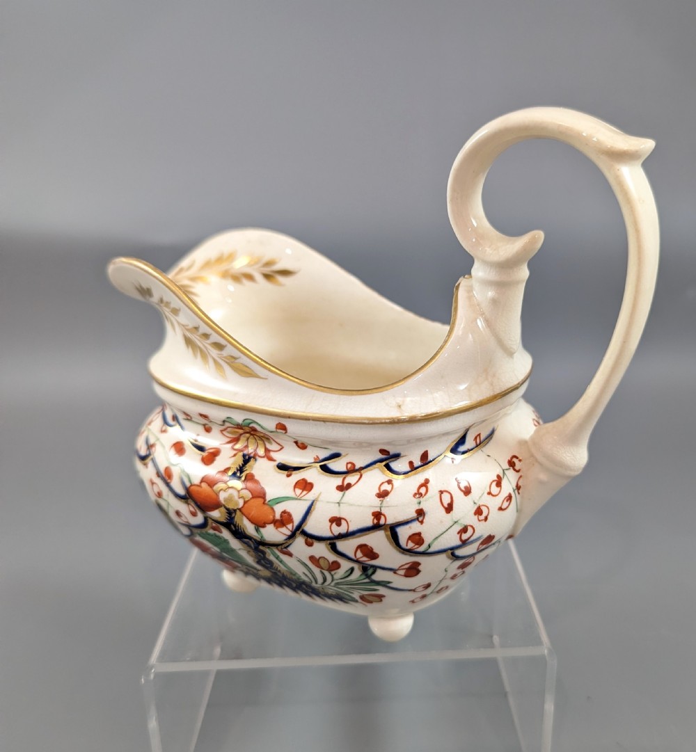 An antique cream-coloured porcelain jug featuring a hand-painted Two Quails design with gilded rim detailing and a raised loop handle. View II