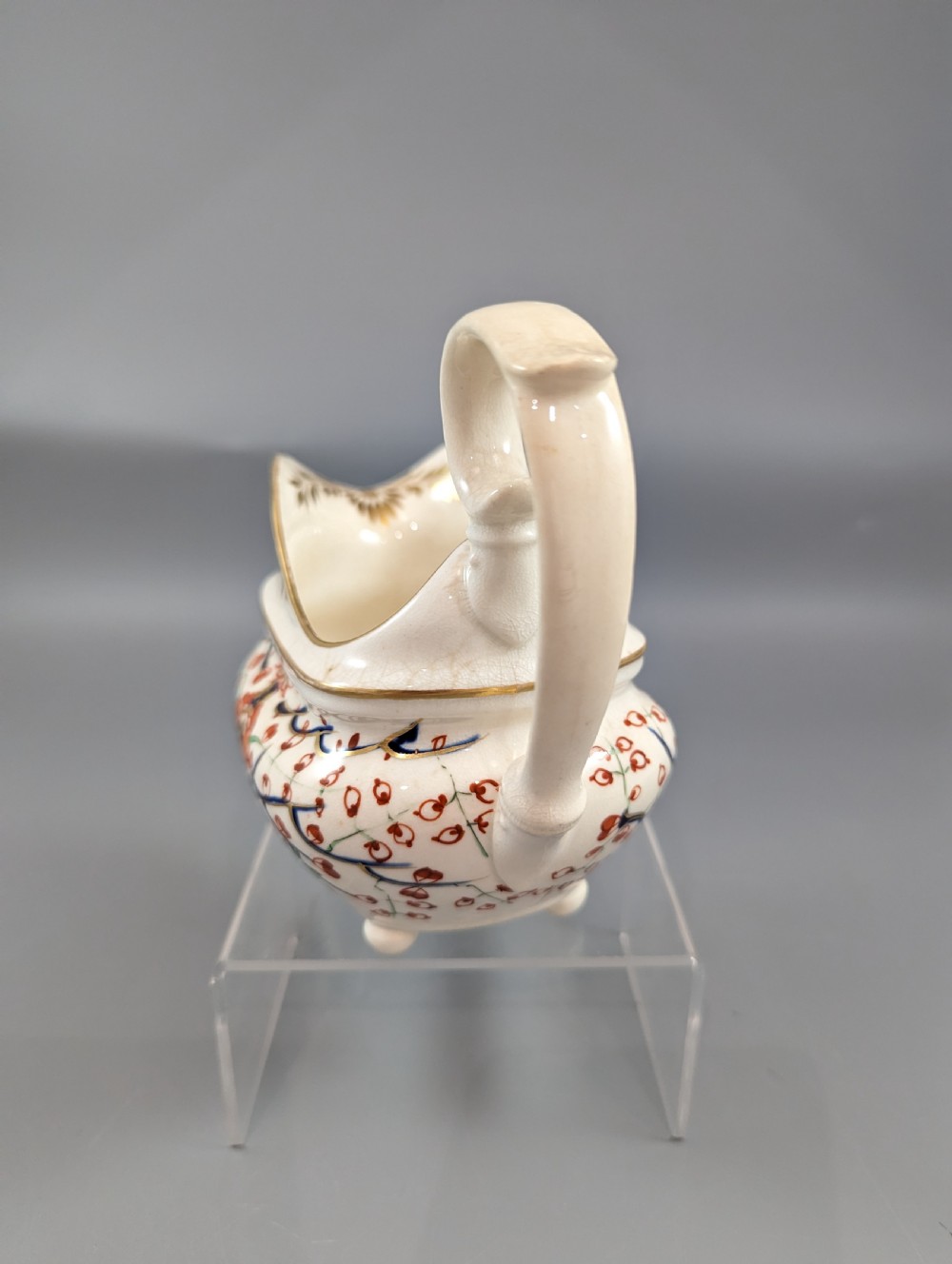 An antique cream-coloured porcelain jug featuring a hand-painted Two Quails design with gilded rim detailing and a raised loop handle. View III