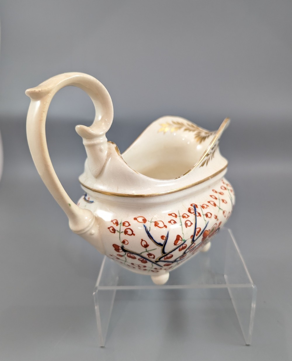 An antique cream-coloured porcelain jug featuring a hand-painted Two Quails design with gilded rim detailing and a raised loop handle. View IV