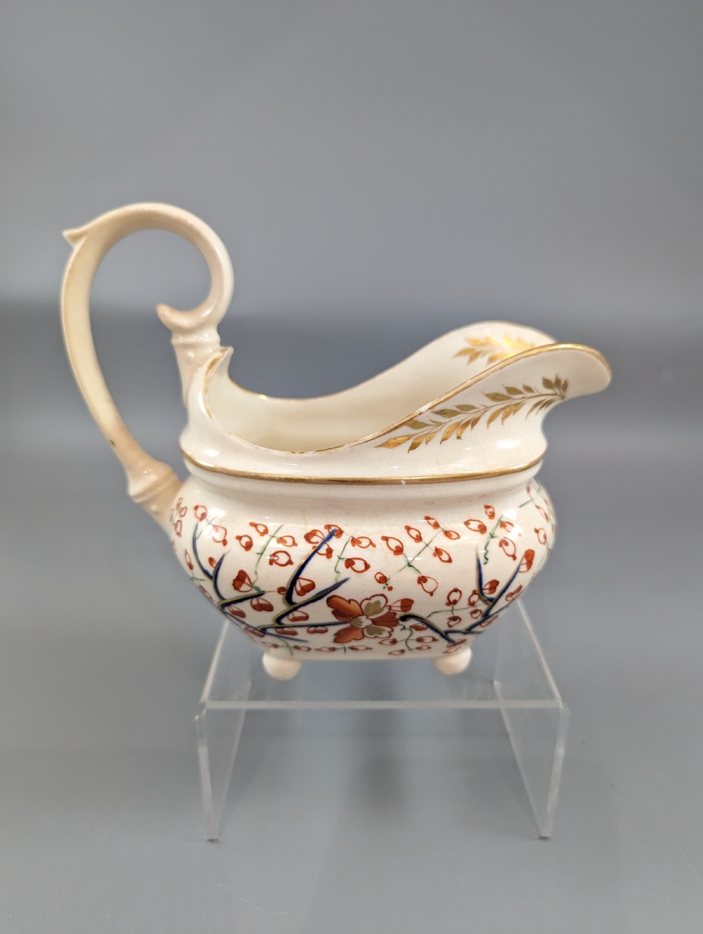 An antique cream-coloured porcelain jug featuring a hand-painted Two Quails design with gilded rim detailing and a raised loop handle. View V