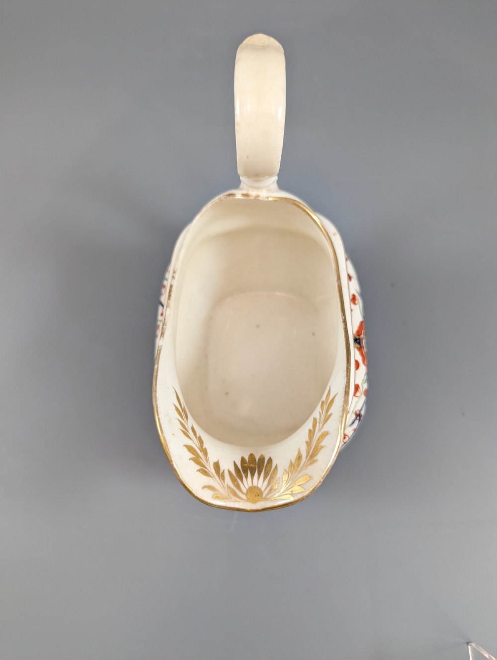 An antique cream-coloured porcelain jug featuring a hand-painted Two Quails design with gilded rim detailing and a raised loop handle. View X