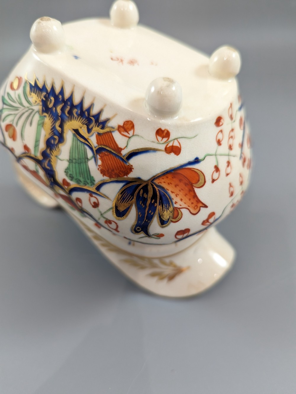 An antique cream-coloured porcelain jug featuring a hand-painted Two Quails design with gilded rim detailing and a raised loop handle. View XII