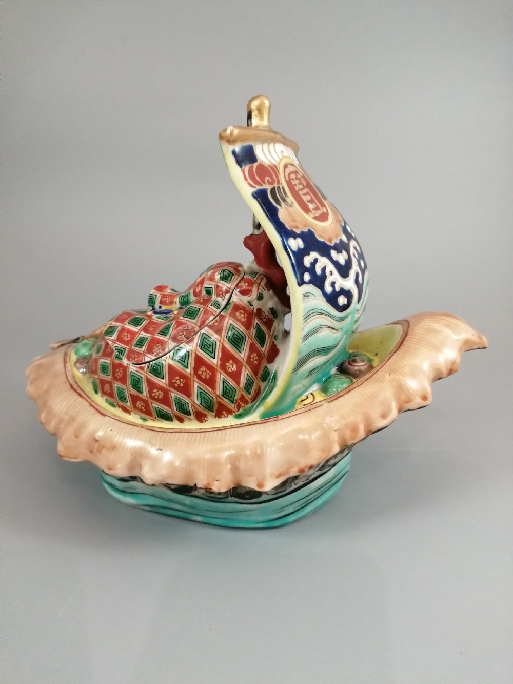A Japanese Kutani porcelain censer shaped like a Takarabune treasure ship decorated with polychrome enamels and a wave-moulded base. View III