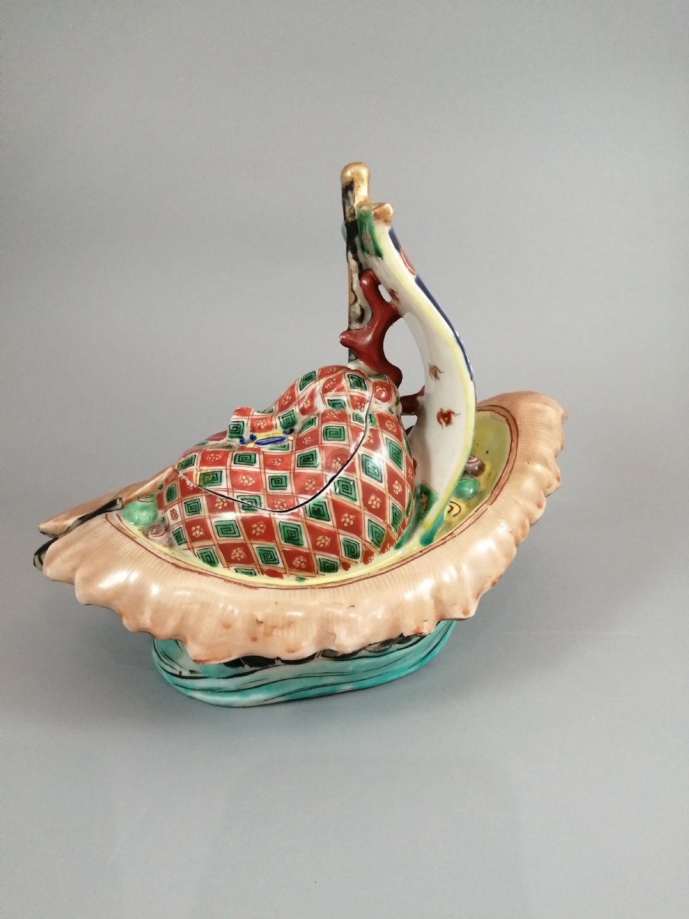 A Japanese Kutani porcelain censer shaped like a Takarabune treasure ship decorated with polychrome enamels and a wave-moulded base. View IV