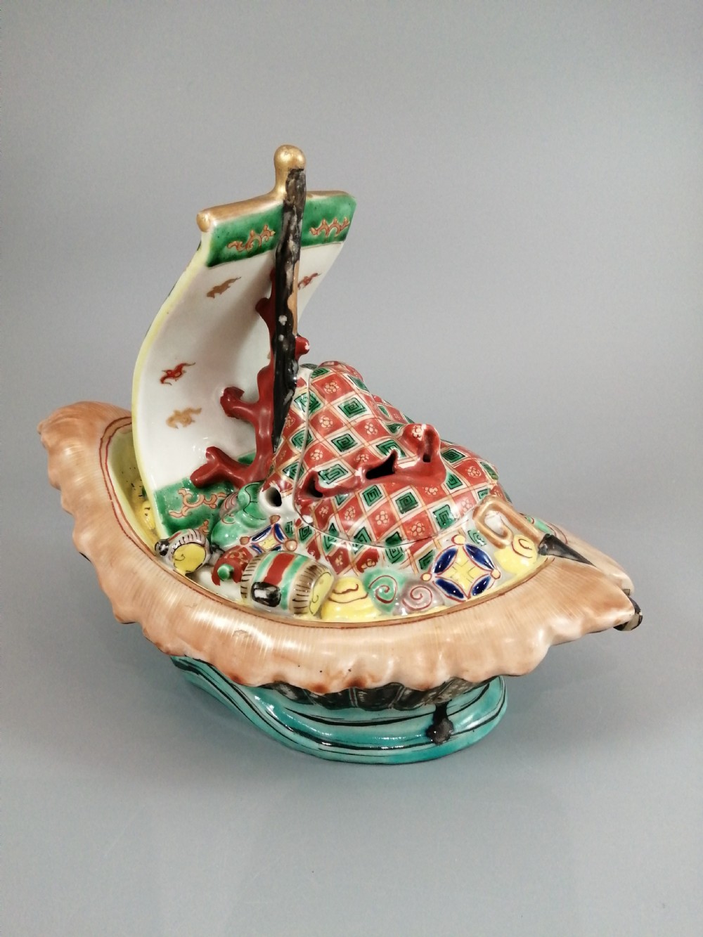 A Japanese Kutani porcelain censer shaped like a Takarabune treasure ship decorated with polychrome enamels and a wave-moulded base. View VII