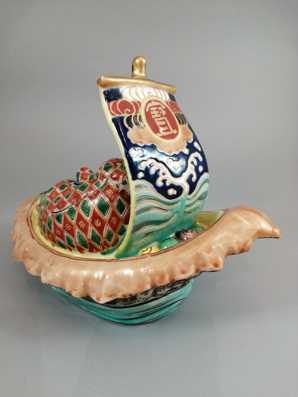 A Japanese Kutani porcelain censer shaped like a Takarabune treasure ship decorated with polychrome enamels and a wave-moulded base. View XI