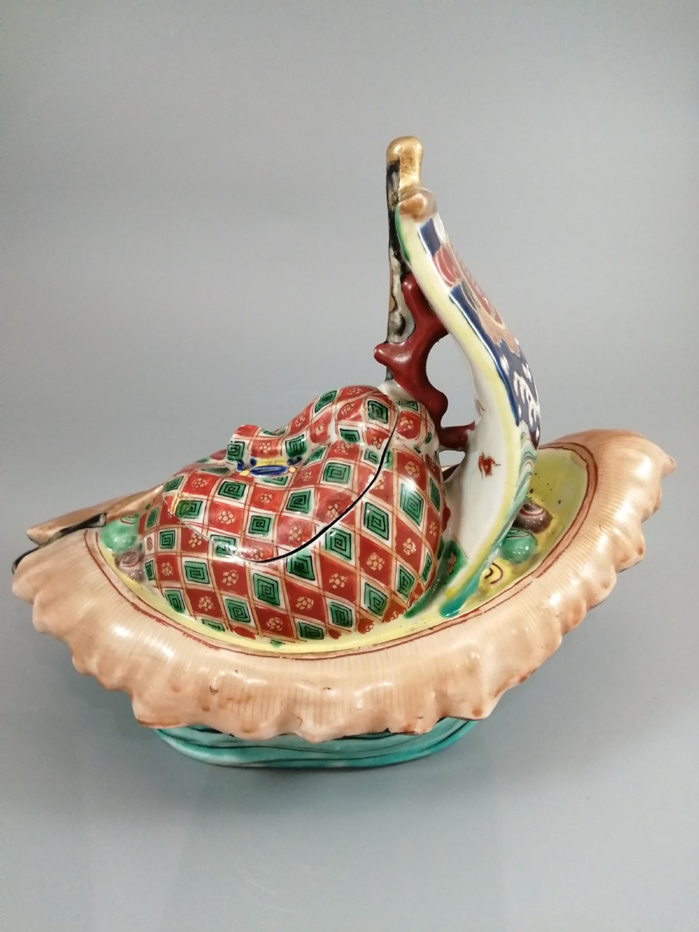 A Japanese Kutani porcelain censer shaped like a Takarabune treasure ship decorated with polychrome enamels and a wave-moulded base. View XII