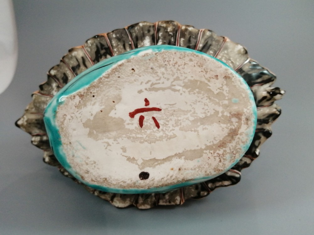 A Japanese Kutani porcelain censer shaped like a Takarabune treasure ship decorated with polychrome enamels and a wave-moulded base. View XVII