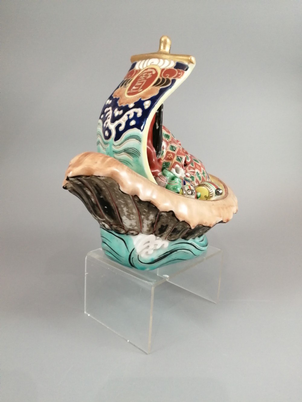 A Japanese Kutani porcelain censer shaped like a Takarabune treasure ship decorated with polychrome enamels and a wave-moulded base. View XVIII