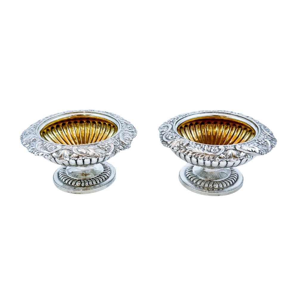 Pair of George III sterling silver gilt urn-shaped pedestal open salts trimmed with foliage, Rebecca Emes (rare woman silversmith)