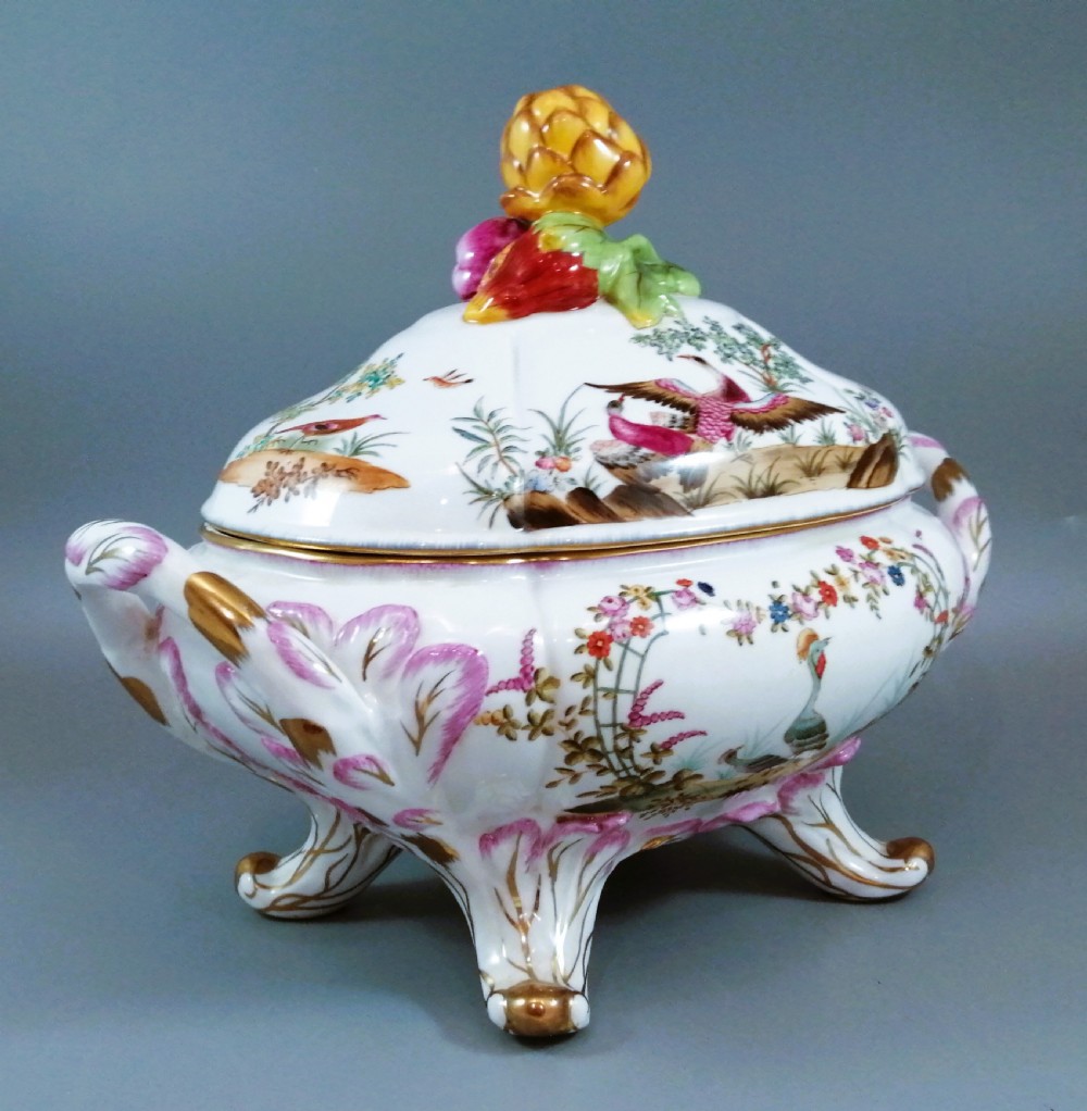 An antique continental porcelain soup tureen with a fruit finial lid, dual handles, and matching underplate, decorated with hand-painted birds and gilded scrollwork. View III