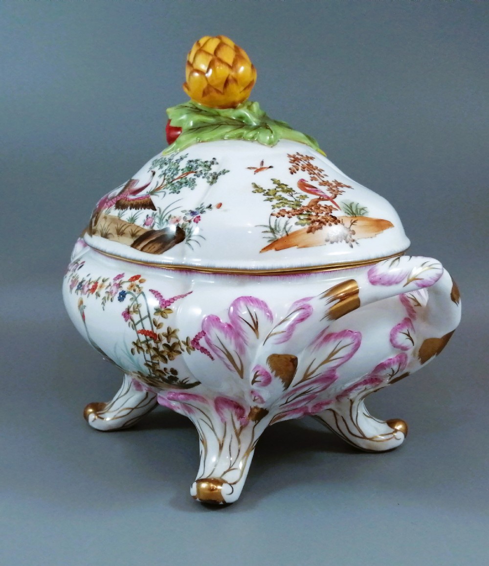 An antique continental porcelain soup tureen with a fruit finial lid, dual handles, and matching underplate, decorated with hand-painted birds and gilded scrollwork. View V