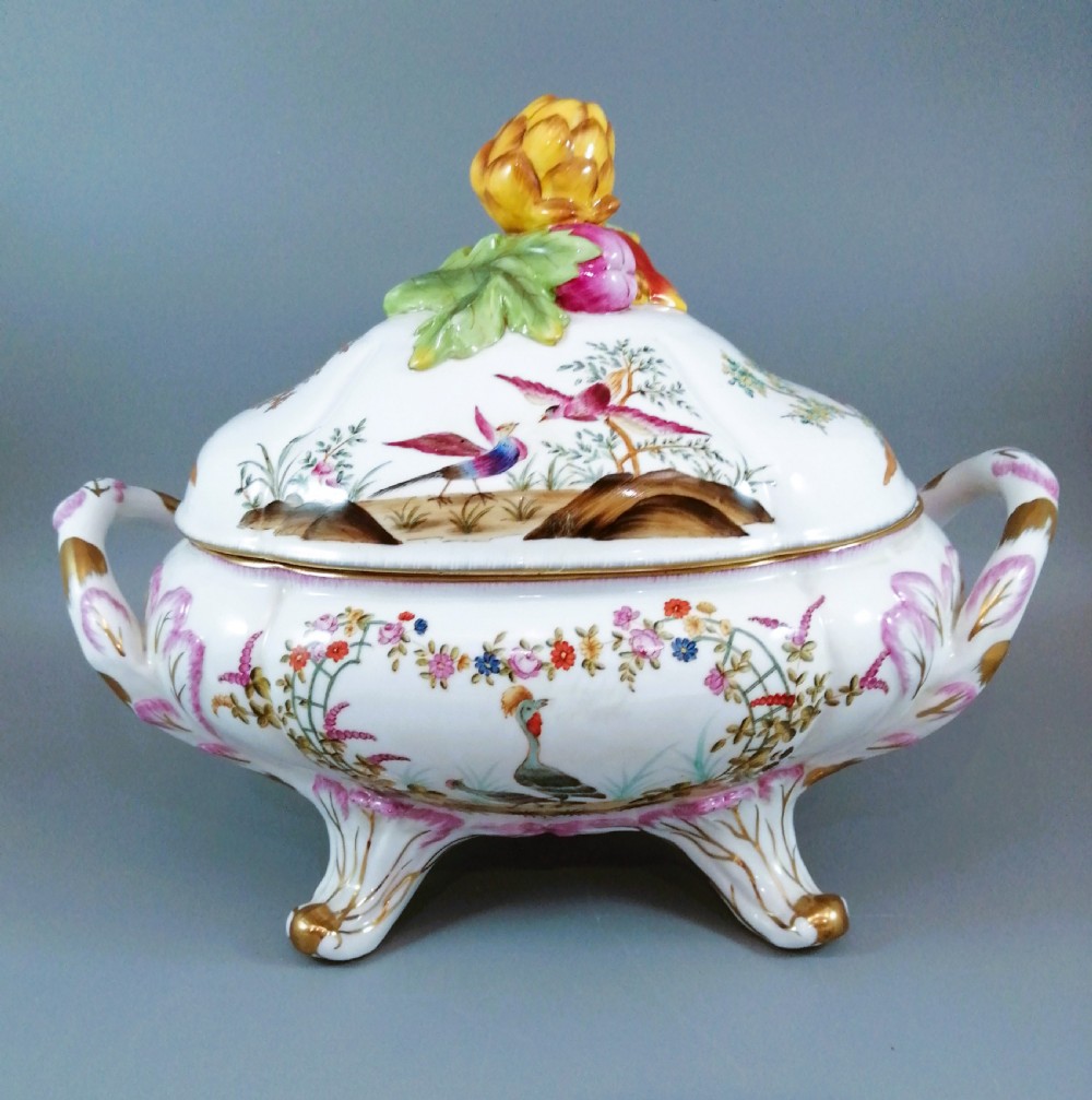 An antique continental porcelain soup tureen with a fruit finial lid, dual handles, and matching underplate, decorated with hand-painted birds and gilded scrollwork. View VII
