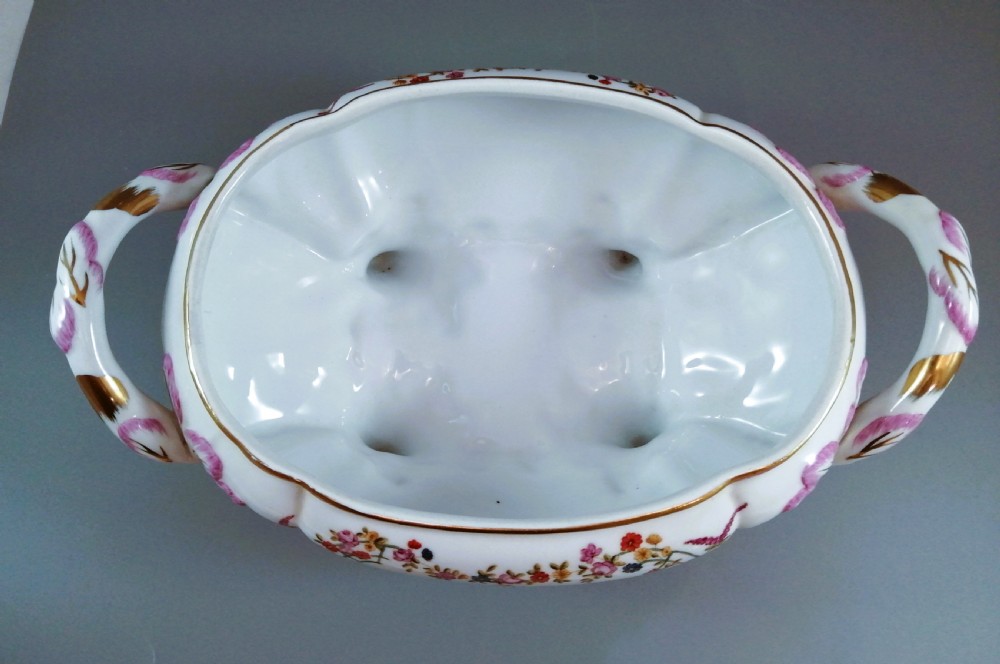 An antique continental porcelain soup tureen with a fruit finial lid, dual handles, and matching underplate, decorated with hand-painted birds and gilded scrollwork. View VIII