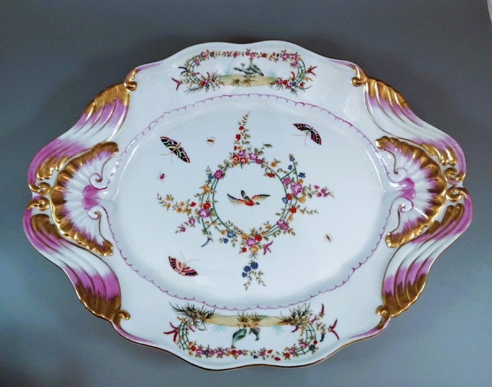An antique continental porcelain soup tureen with a fruit finial lid, dual handles, and matching underplate, decorated with hand-painted birds and gilded scrollwork. View XIV