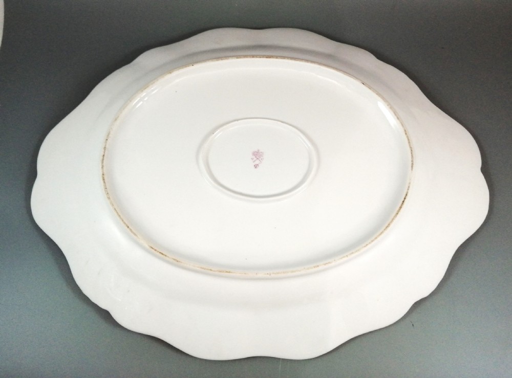 An antique continental porcelain soup tureen with a fruit finial lid, dual handles, and matching underplate, decorated with hand-painted birds and gilded scrollwork. View XV