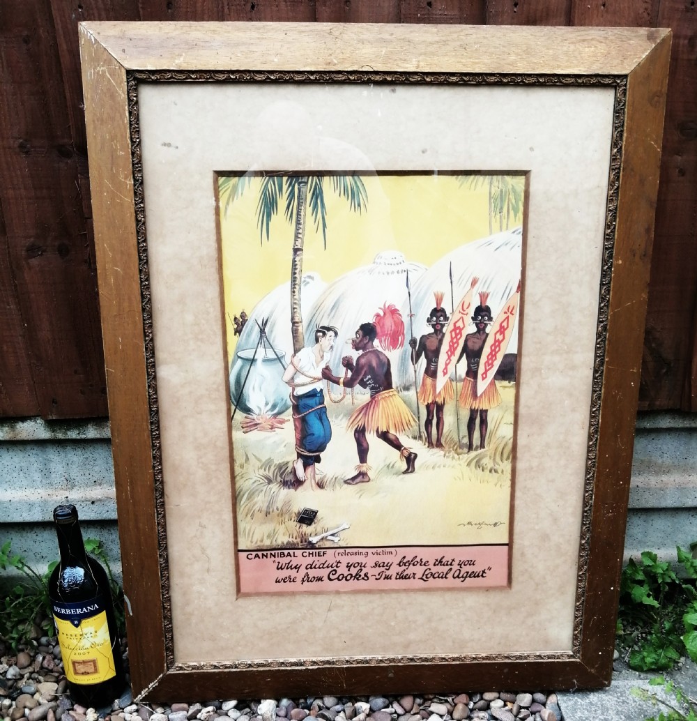 A framed 1930s colour travel agency cartoon advertisement illustrating a scene with a traveler tied to a tree near tropical huts and a cooking pot. View V