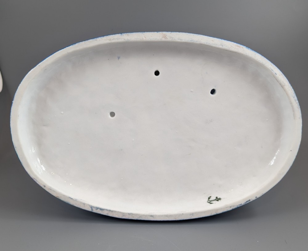 Late 19th-century French blue and white glazed porcelain figurine group depicting four figures gathered around a table fortune-telling on an oval blue base. View XVI