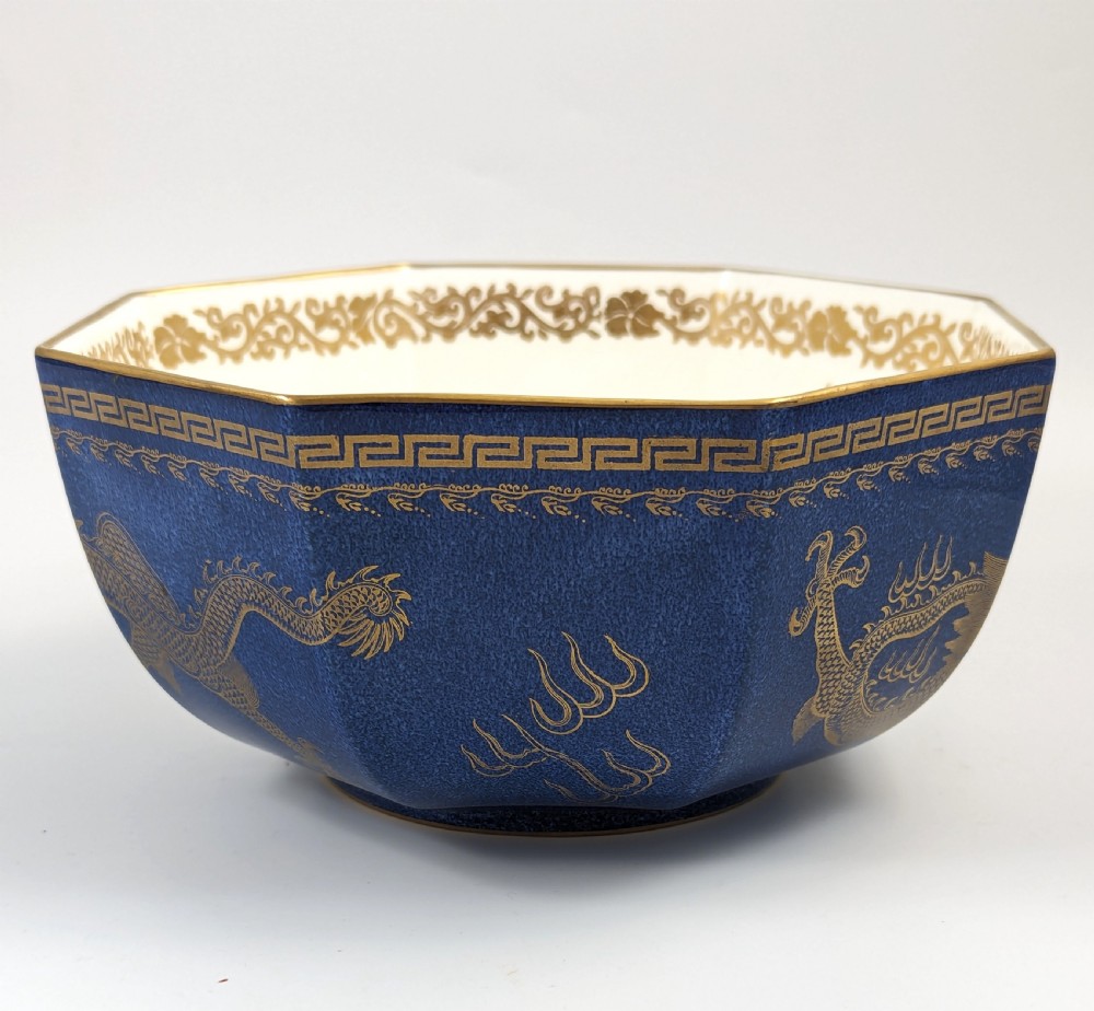 An octagonal cobalt blue ceramic bowl featuring gilded celestial dragon motifs and a Greek key upper rim. View III