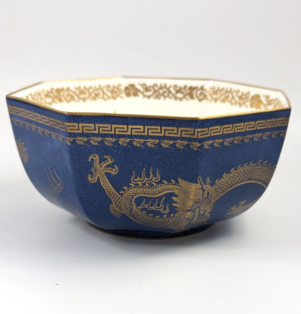 An octagonal cobalt blue ceramic bowl featuring gilded celestial dragon motifs and a Greek key upper rim. View IV