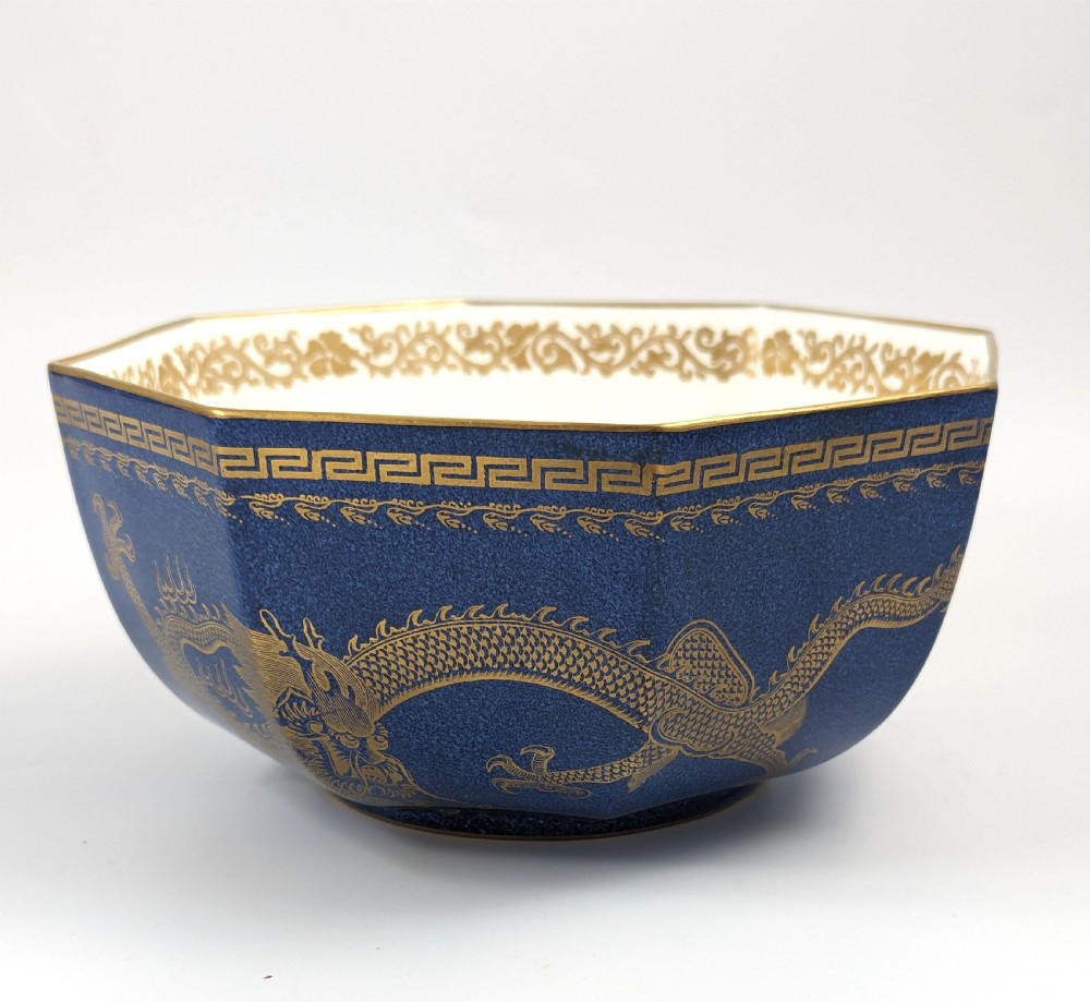 An octagonal cobalt blue ceramic bowl featuring gilded celestial dragon motifs and a Greek key upper rim. View V