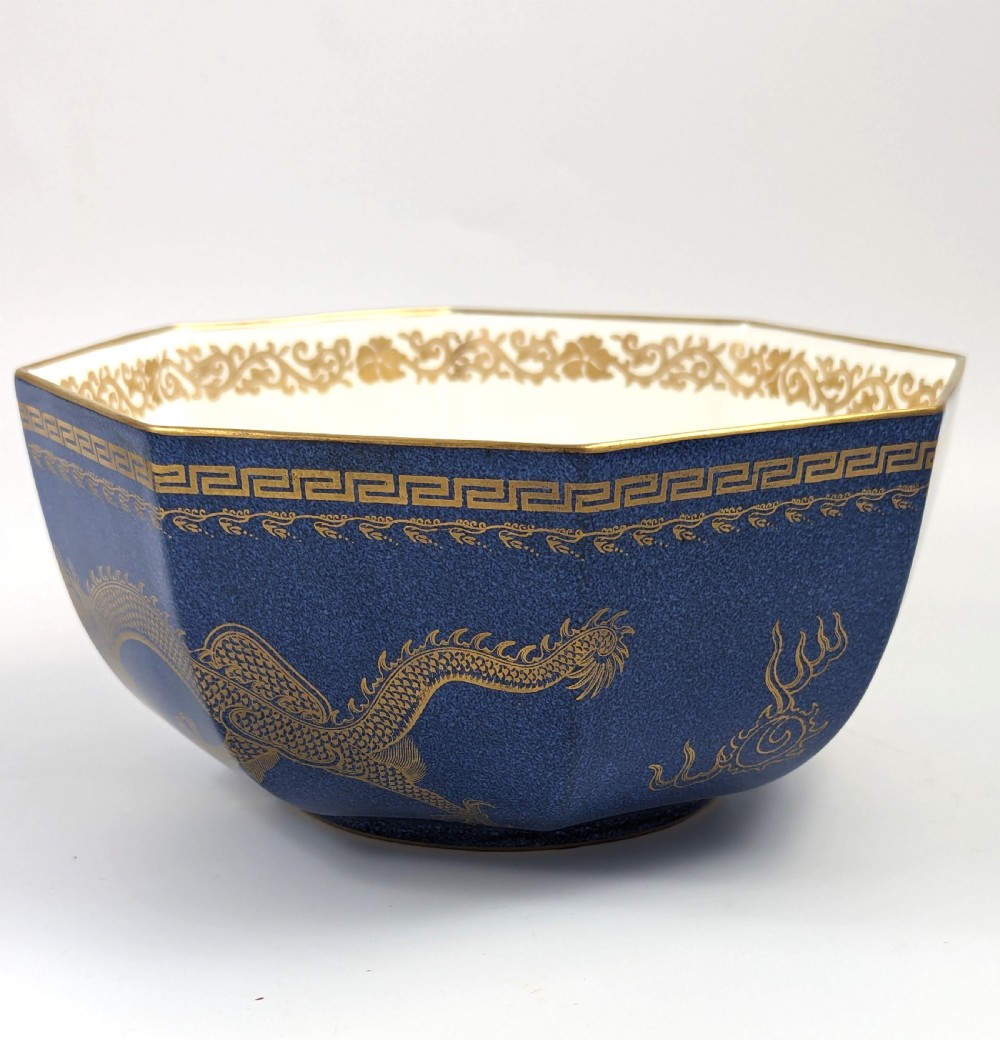 An octagonal cobalt blue ceramic bowl featuring gilded celestial dragon motifs and a Greek key upper rim. View VI