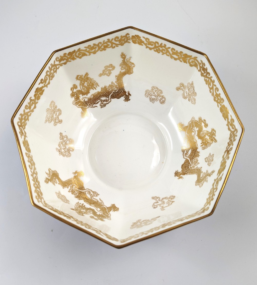 An octagonal cobalt blue ceramic bowl featuring gilded celestial dragon motifs and a Greek key upper rim. View X