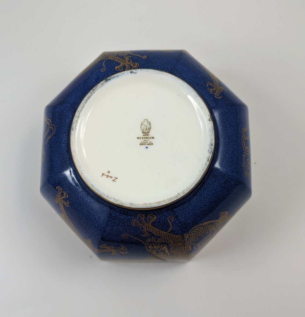 An octagonal cobalt blue ceramic bowl featuring gilded celestial dragon motifs and a Greek key upper rim. View XXI