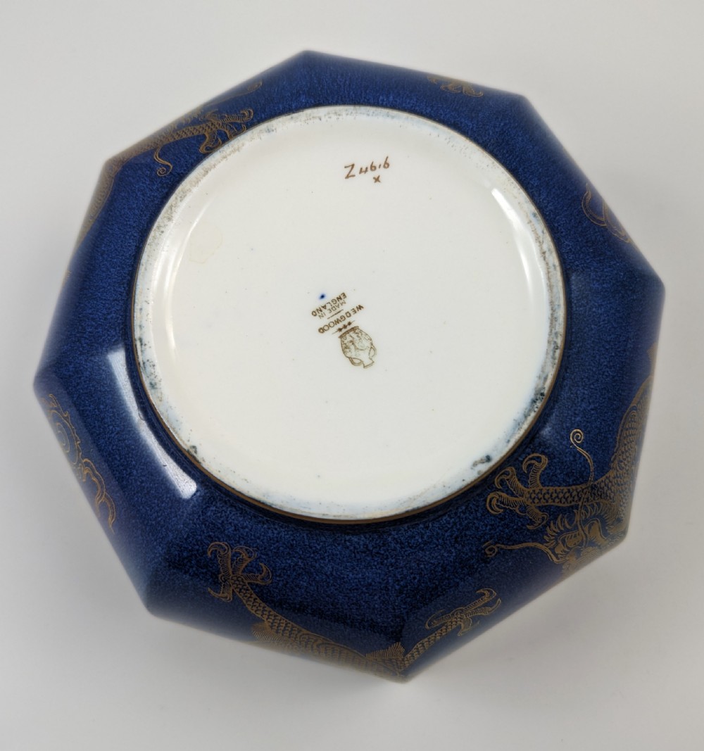 An octagonal cobalt blue ceramic bowl featuring gilded celestial dragon motifs and a Greek key upper rim. View XXII