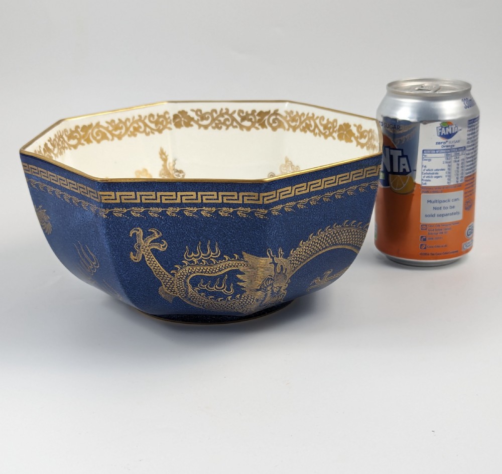 An octagonal cobalt blue ceramic bowl featuring gilded celestial dragon motifs and a Greek key upper rim. View XXIII