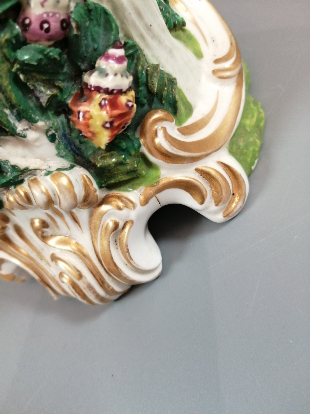 A Bloor Derby porcelain figure of Neptune standing atop a shell and rockwork base with sea creatures, wearing a crown and drapery decorated in gold leaf and blue enamel. View XV