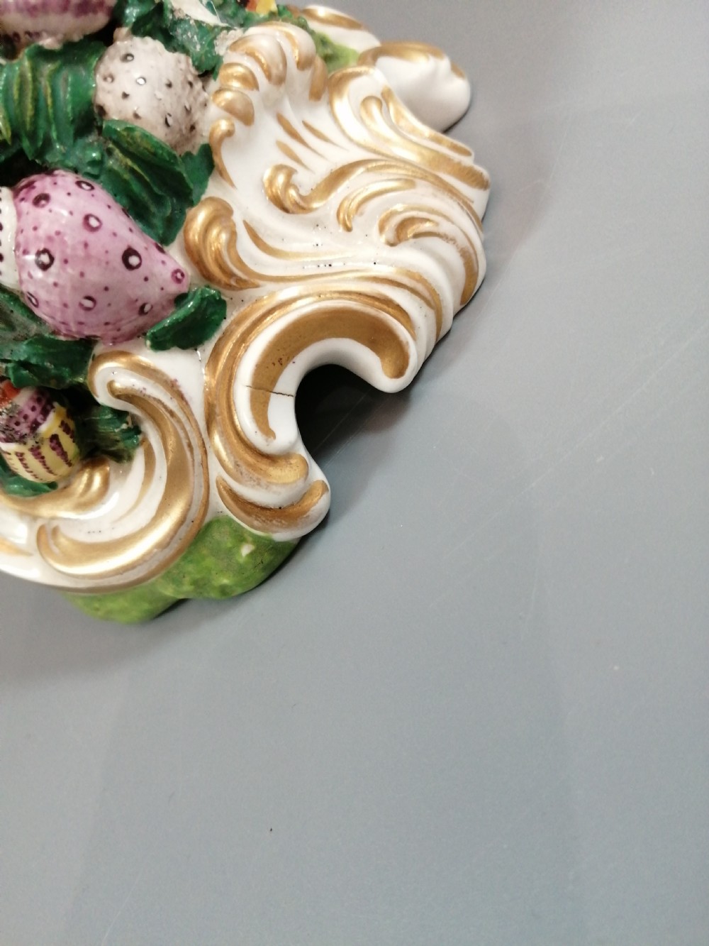 A Bloor Derby porcelain figure of Neptune standing atop a shell and rockwork base with sea creatures, wearing a crown and drapery decorated in gold leaf and blue enamel. View XVI