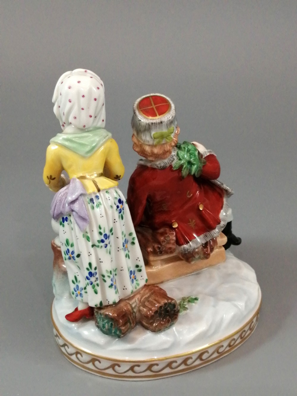 A Carl Thieme Potschappel hand-painted porcelain figurine depicting a young couple in eighteenth-century winter costume beside a sledge and brazier. View IV